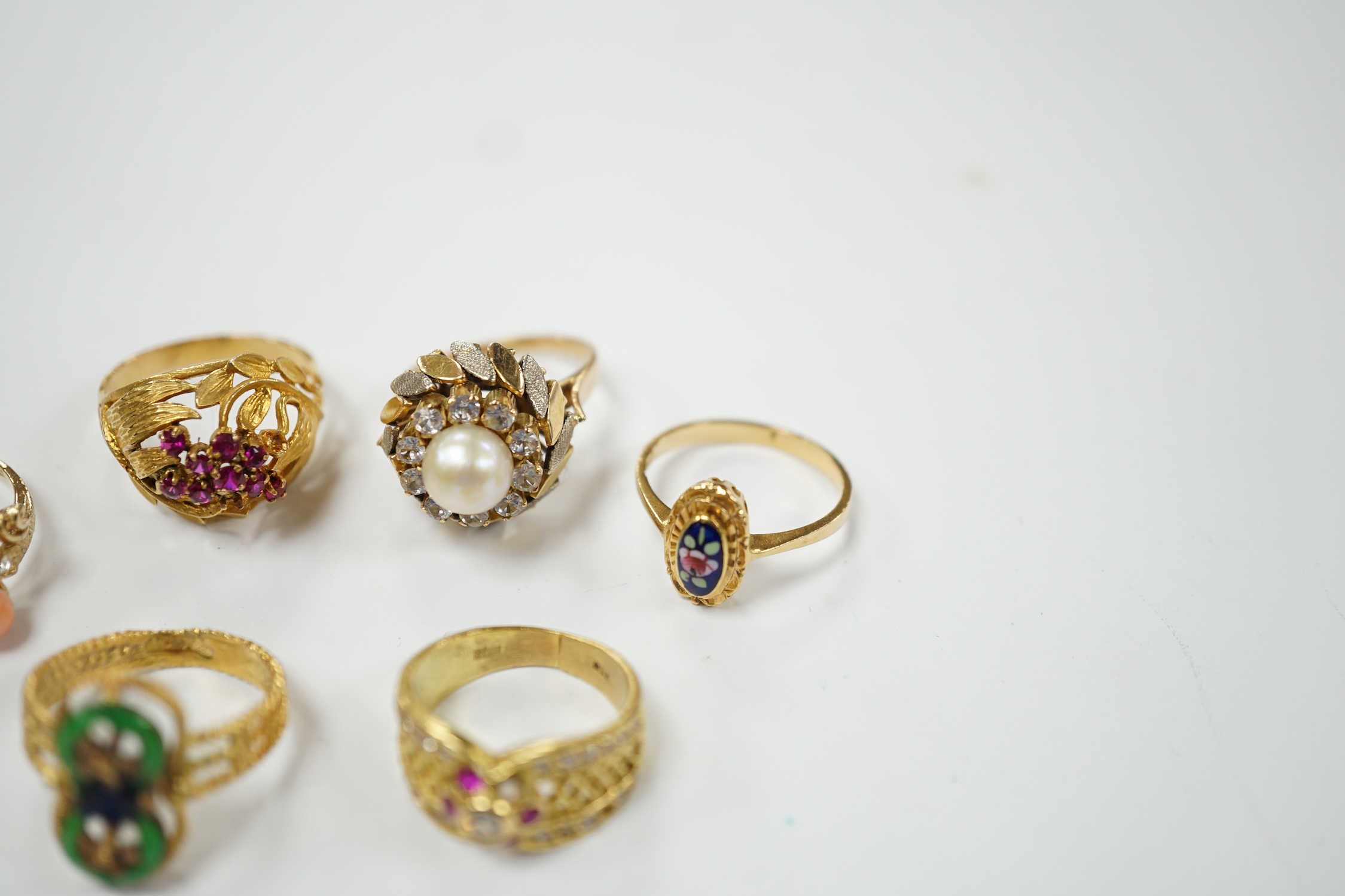 A Middle Eastern 750 yellow metal and two colour enamel up-finger ring, size M, a Chinese 750 yellow metal and gem set cluster ring, gross weight 9.4 grams, a 14k and jade set ring, gross weight 2.8 grams and three assor